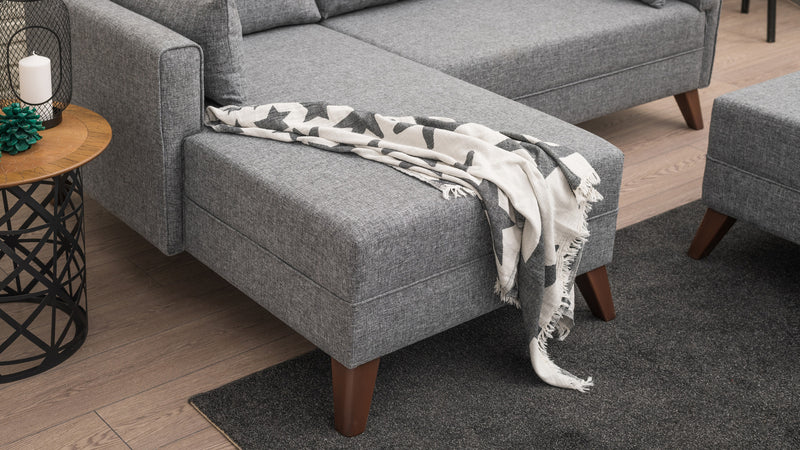 Divano letto moderno con penisola e pouf in tessuto cm 205x140x80h - vari colori