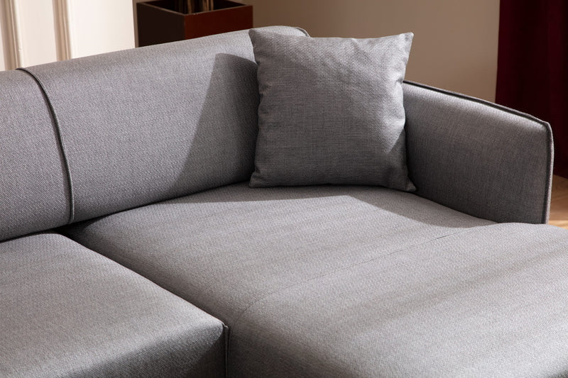 Divano angolare moderno con penisola in tessuto trasformabile in letto cm 270x140x67h - vari colori