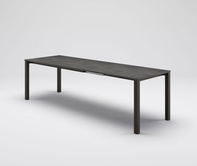 tavolo da pranzo allungabile piano cemento kira gambe in metallo colore bronzo