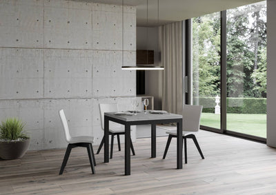 tavolo moderno allungabile quadrato piano cemento gambe in metallo