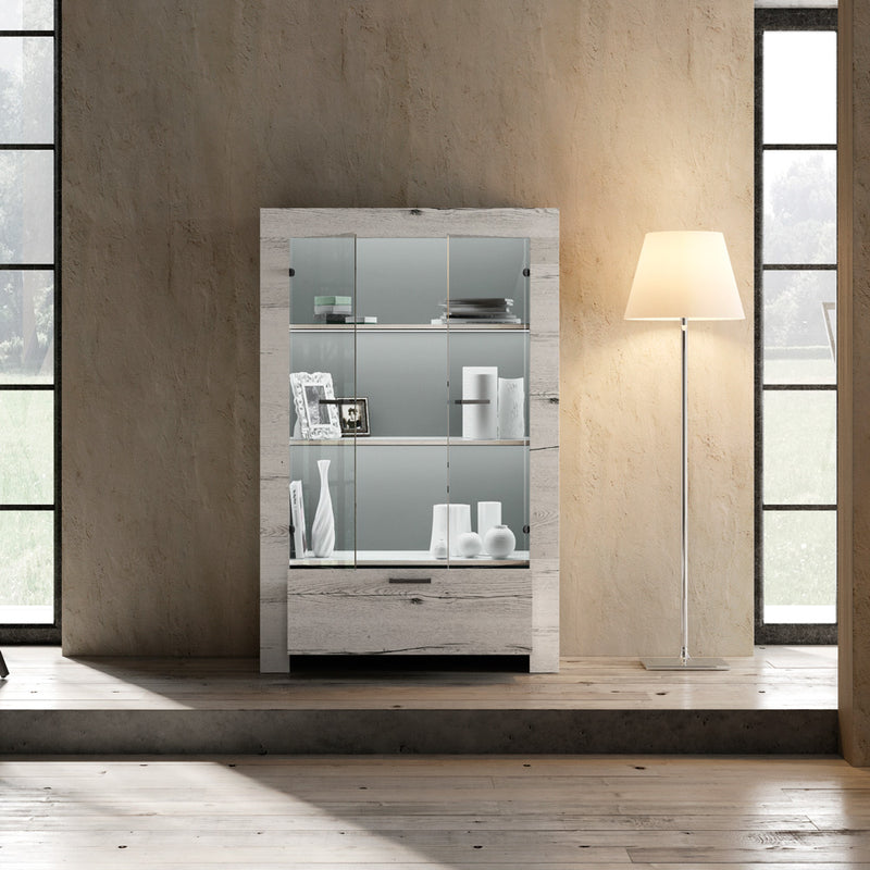 Revel - Vetrina 2 ante con cassetto in legno rovere cm 102x43x158h - vari colori